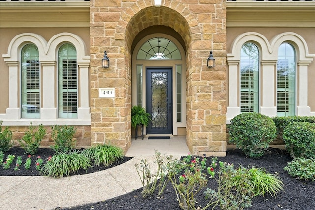 doorway to property with stone siding