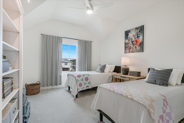 carpeted bedroom featuring lofted ceiling and a ceiling fan