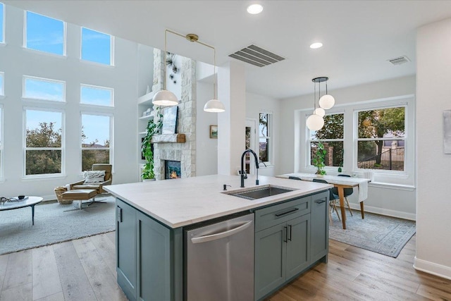 kitchen featuring dishwasher, a sink, visible vents, and gray cabinetry