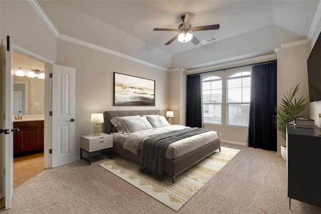 bedroom featuring light carpet, a tray ceiling, visible vents, and crown molding