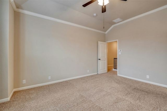 carpeted empty room with baseboards, visible vents, a ceiling fan, lofted ceiling, and ornamental molding