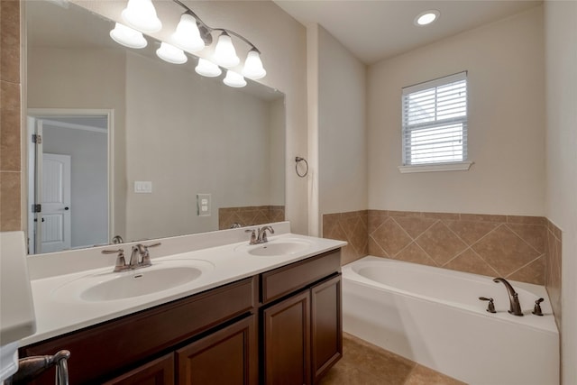 bathroom with a garden tub, a sink, an inviting chandelier, and double vanity