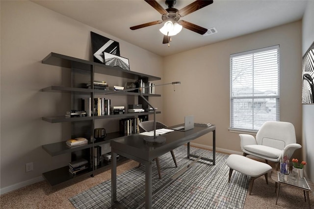 home office with a ceiling fan, visible vents, and baseboards