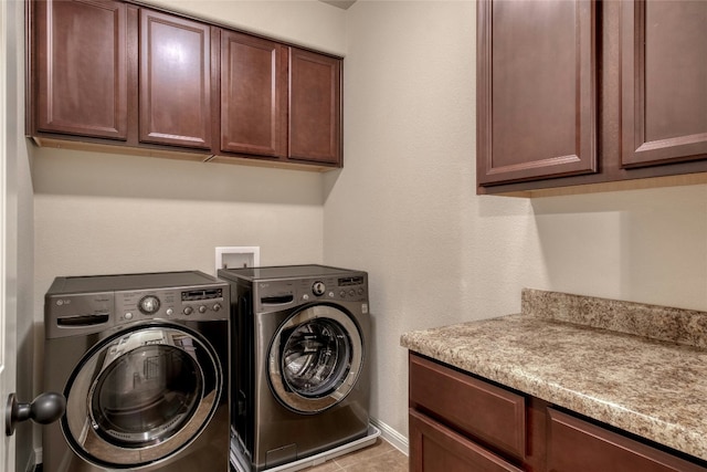 laundry area with cabinet space, baseboards, washer and dryer, and tile patterned floors