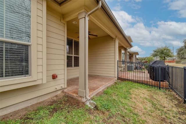 view of home's exterior with a patio area, ceiling fan, and fence