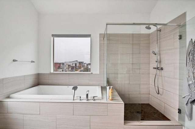 bathroom featuring a garden tub and a shower stall