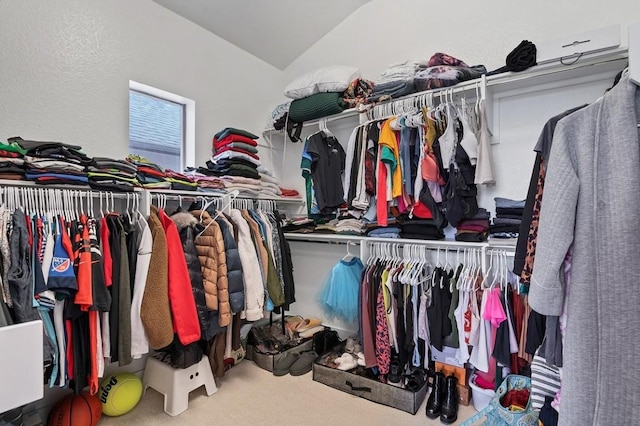 spacious closet featuring lofted ceiling and carpet flooring