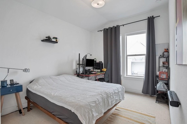 bedroom with carpet floors and vaulted ceiling