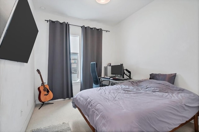 bedroom featuring carpet and baseboards