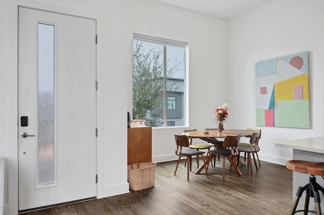 dining space featuring a healthy amount of sunlight, baseboards, and dark wood finished floors