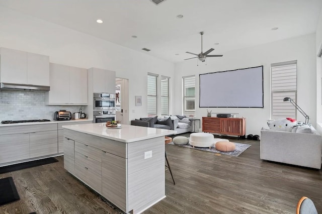 kitchen featuring double oven, modern cabinets, gas cooktop, and open floor plan