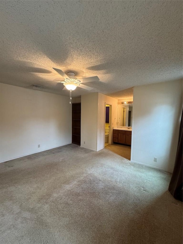 interior space with light carpet, a textured ceiling, and a ceiling fan