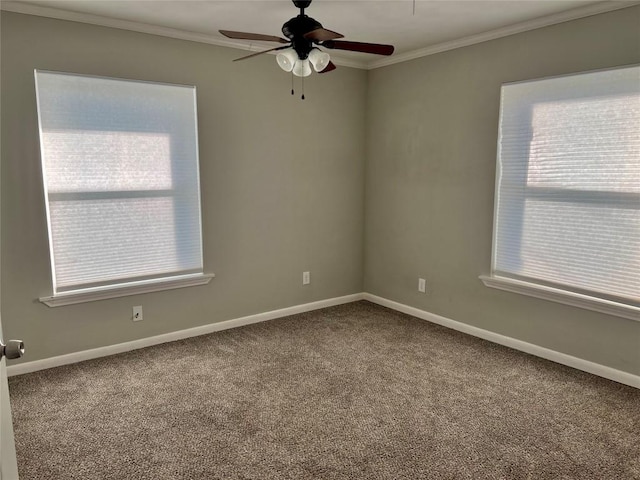 empty room with carpet, baseboards, and crown molding