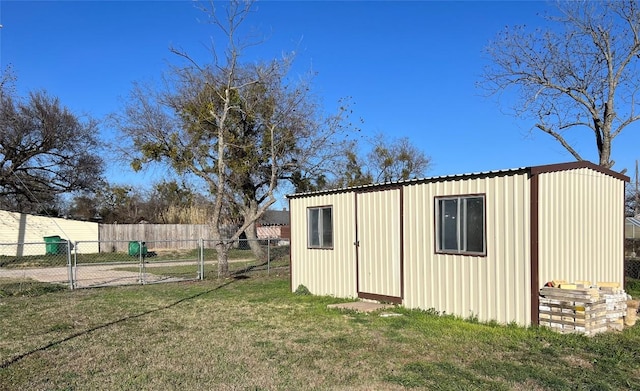 view of outbuilding featuring fence and an outdoor structure