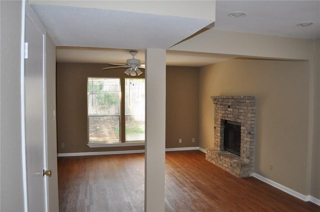 8106 Hood Cir, Austin, TX 78745 - unfurnished living room with wood finished floors, ceiling fan, baseboards, and a fireplace