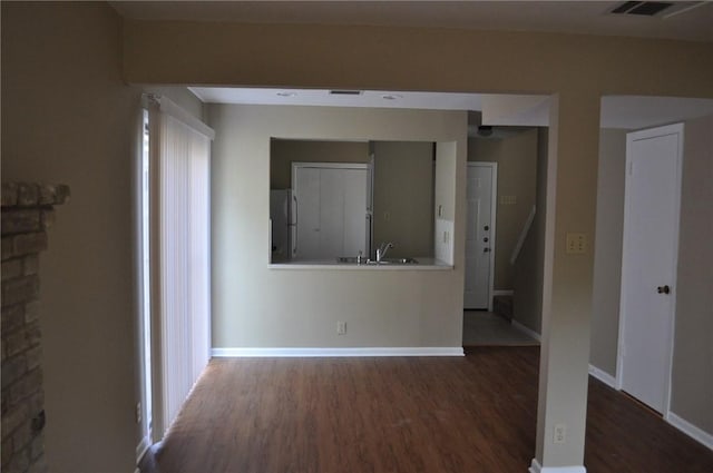 8106 Hood Cir, Austin, TX 78745 - spare room with wood finished floors, a sink, and baseboards