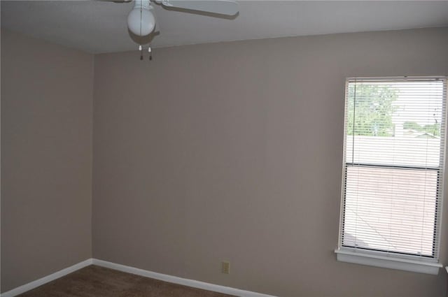 8106 Hood Cir, Austin, TX 78745 - spare room featuring a ceiling fan, dark carpet, and baseboards