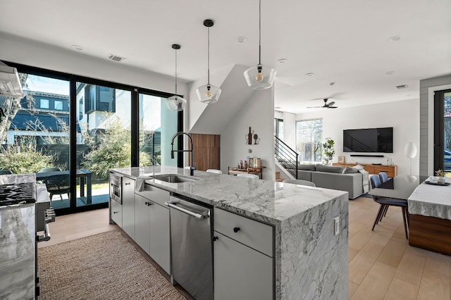 1712 Nash Ave Unit A, Austin, TX 78704 - kitchen featuring stainless steel dishwasher, a sink, healthy amount of natural light, and stove