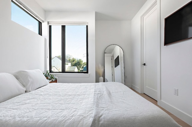 1712 Nash Ave Unit A, Austin, TX 78704 - bedroom with multiple windows, baseboards, and wood finished floors