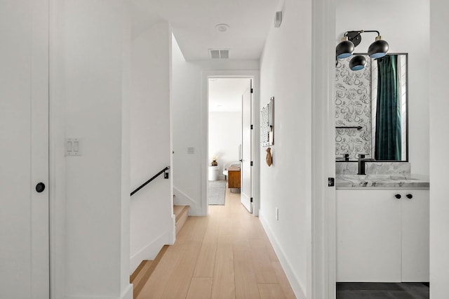 1712 Nash Ave Unit A, Austin, TX 78704 - hallway with light wood finished floors and a sink