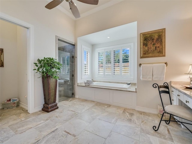 full bathroom with a ceiling fan, a stall shower, a bath, vanity, and baseboards