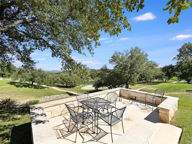 view of patio / terrace with outdoor dining space and golf course view