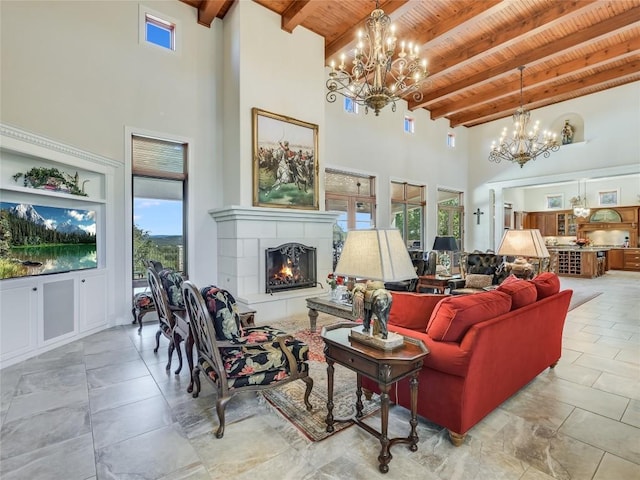 living area featuring beamed ceiling, a towering ceiling, wood ceiling, and an inviting chandelier