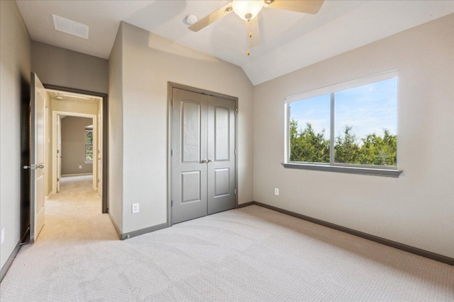 unfurnished bedroom featuring light carpet, a closet, visible vents, and baseboards