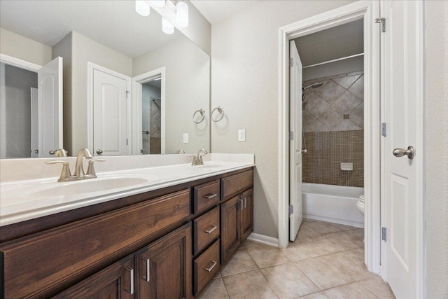 bathroom with double vanity, shower / washtub combination, a sink, and tile patterned floors