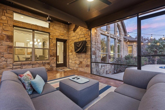 interior space with an outdoor living space and a ceiling fan