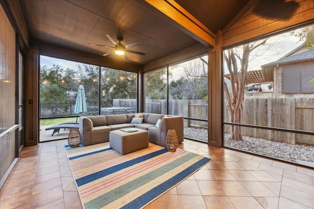 sunroom / solarium with a ceiling fan, a healthy amount of sunlight, and vaulted ceiling