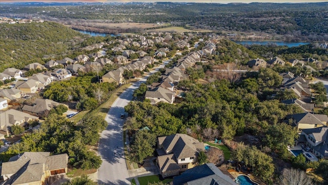 aerial view with a residential view, a water view, and a forest view