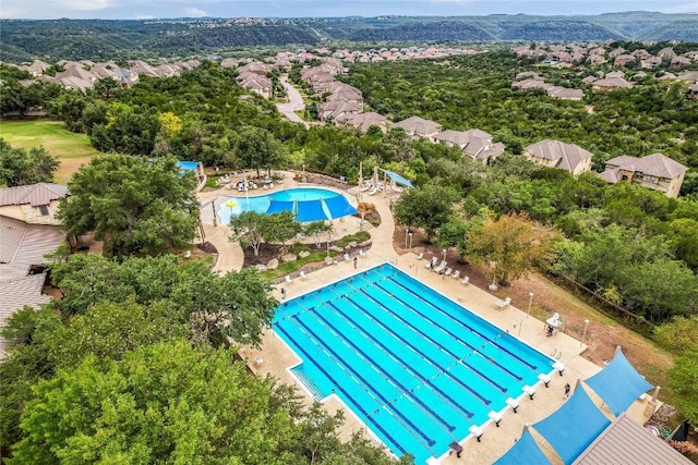 community pool with fence and a patio