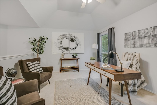 office space featuring a ceiling fan, lofted ceiling, light carpet, and baseboards