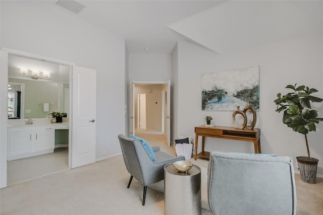 sitting room with light carpet and baseboards