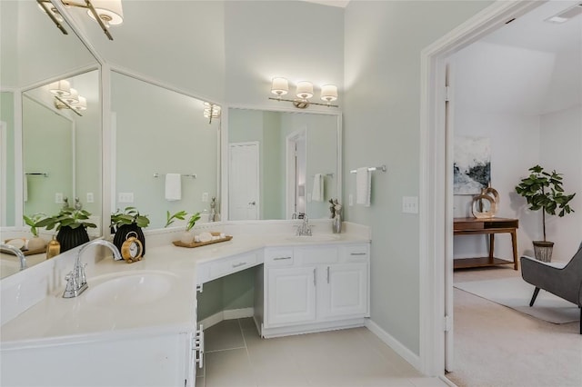 bathroom featuring double vanity, a sink, visible vents, and tile patterned floors