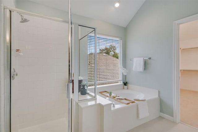 full bath featuring a stall shower, vaulted ceiling, and a bath