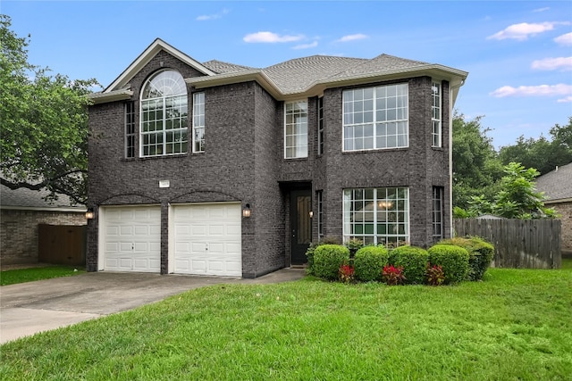 view of front facade with a garage, concrete driveway, fence, a front lawn, and brick siding