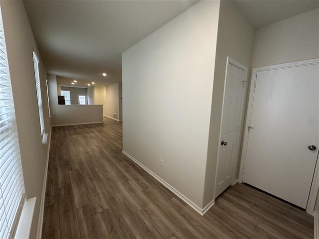 hallway with baseboards and dark wood finished floors