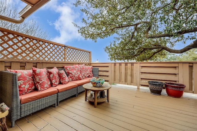 wooden deck with an outdoor living space