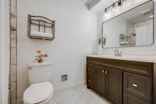 bathroom featuring curtained shower, vanity, toilet, and baseboards