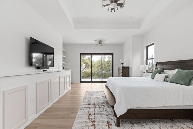 1105 Oak Hurst Rd, Austin, TX 78734 - bedroom featuring access to outside, light wood finished floors, and a tray ceiling