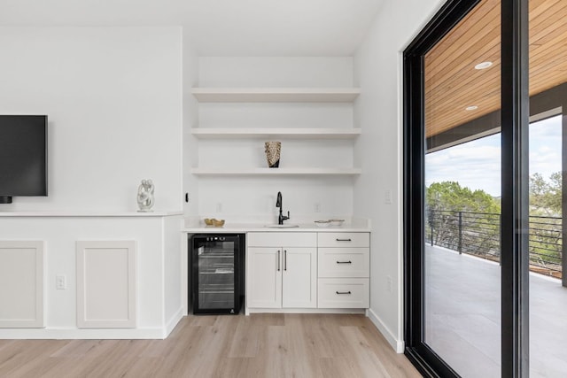 1105 Oak Hurst Rd, Austin, TX 78734 - indoor wet bar with wine cooler and light wood-style floors
