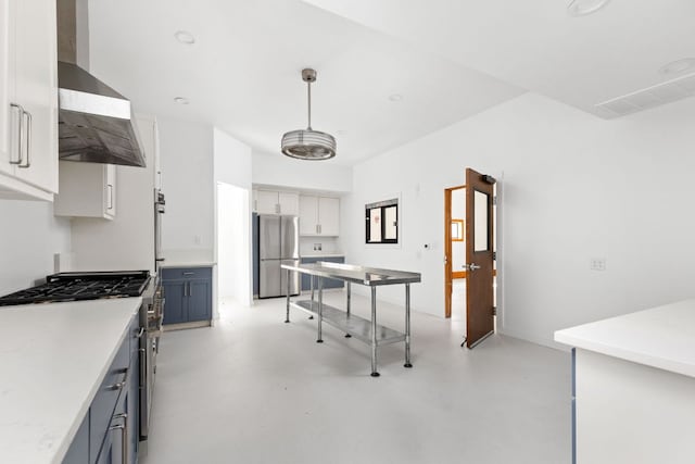 1105 Oak Hurst Rd, Austin, TX 78734 - kitchen with appliances with stainless steel finishes, wall chimney range hood, light countertops, concrete flooring, and decorative light fixtures