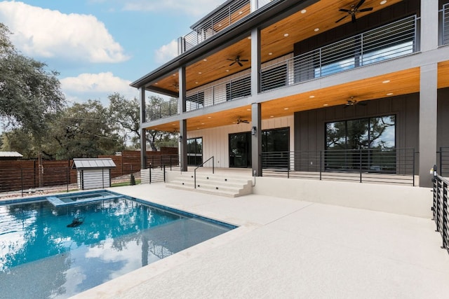 1105 Oak Hurst Rd, Austin, TX 78734 - view of swimming pool with a ceiling fan, a patio area, a pool with connected hot tub, and a storage shed