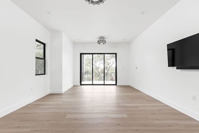 1105 Oak Hurst Rd, Austin, TX 78734 - unfurnished living room featuring plenty of natural light and light wood-type flooring