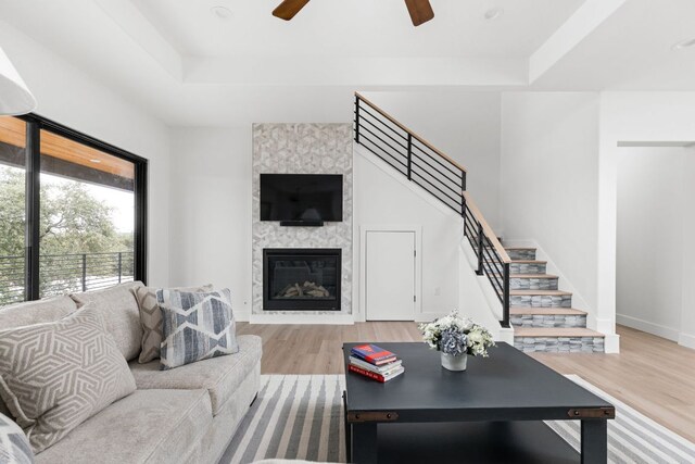 1105 Oak Hurst Rd, Austin, TX 78734 - living area featuring light wood-type flooring, a ceiling fan, stairs, and a large fireplace