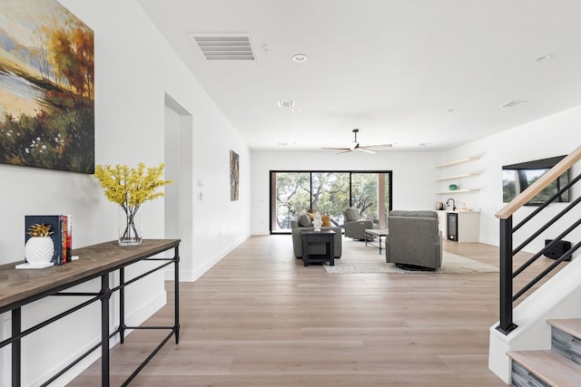 1105 Oak Hurst Rd, Austin, TX 78734 - living area with stairs, light wood-style flooring, and a ceiling fan