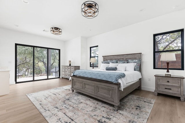 1105 Oak Hurst Rd, Austin, TX 78734 - bedroom featuring multiple windows, light wood finished floors, and access to outside