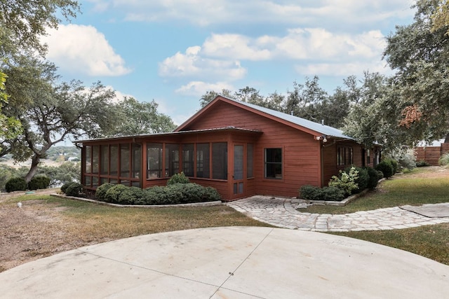 1105 Oak Hurst Rd, Austin, TX 78734 - view of front of home with a sunroom, a patio area, and a front lawn